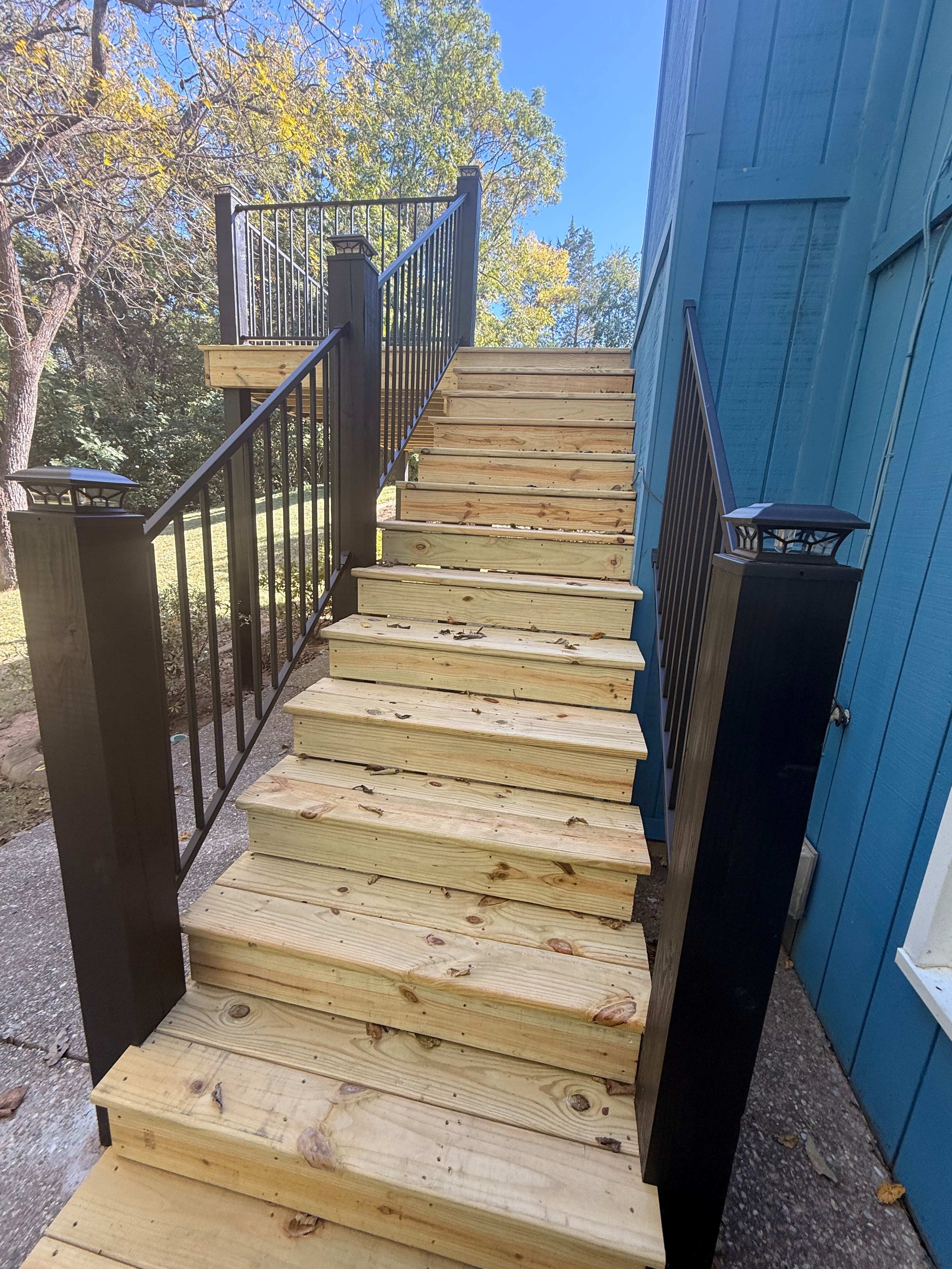 Completed deck replacement with wood railings — Louisville, KY